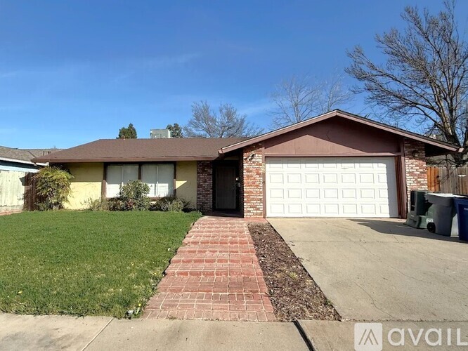 A house with a brown roof and a white garage door.