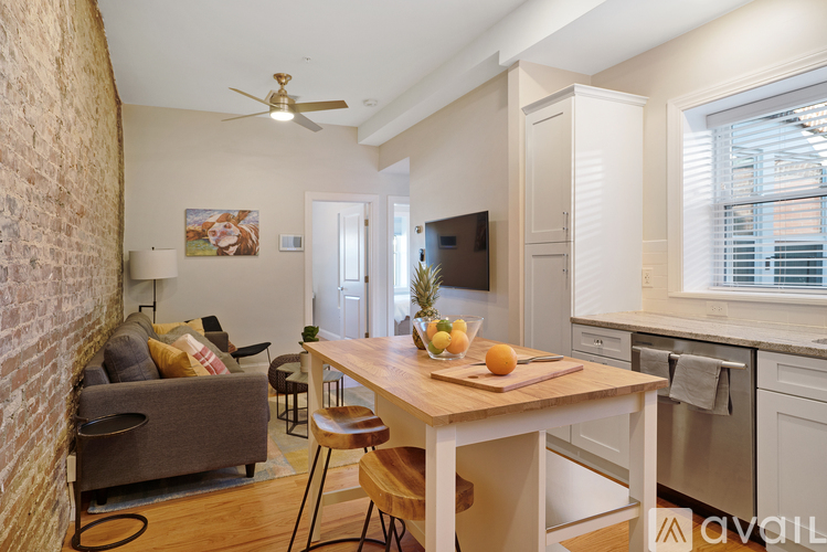 A kitchen with a table and chairs in the middle of the room.