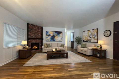 A living room with a fireplace and a painting on the wall.