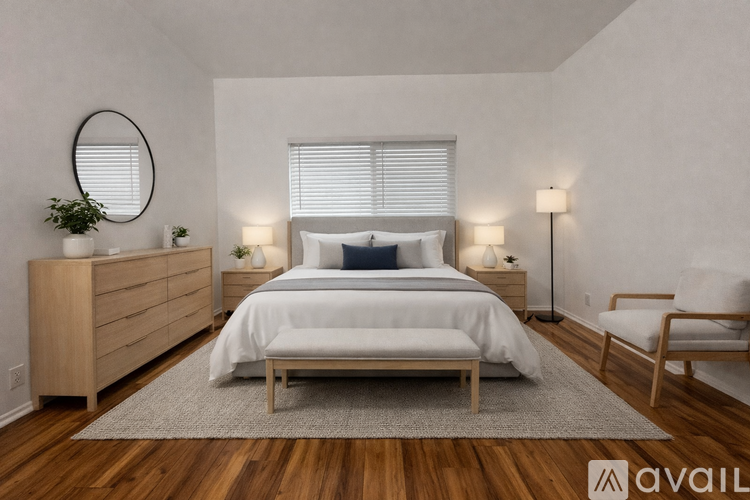 A bedroom with a bed, nightstand, and chair.