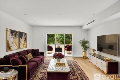 A living room with a red couch and a coffee table.