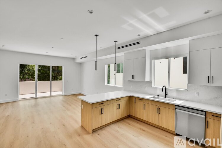 A modern kitchen with wooden cabinets and a large island.