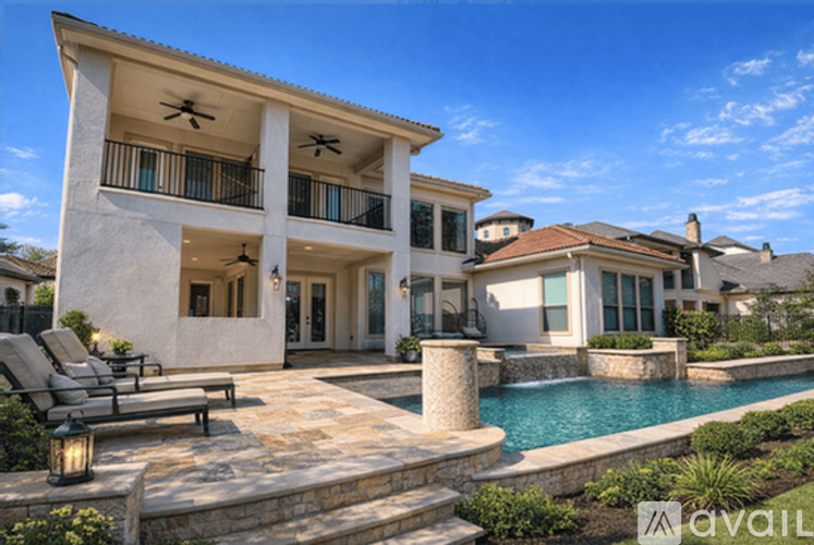 A large house with a pool in front.