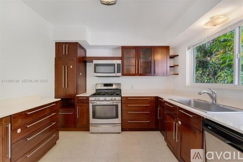 A kitchen with wooden cabinets and a stainless steel oven.