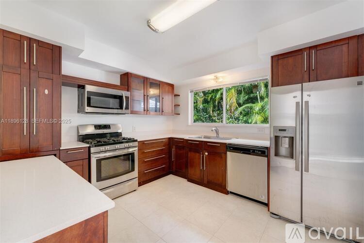A kitchen with wooden cabinets and stainless steel appliances.