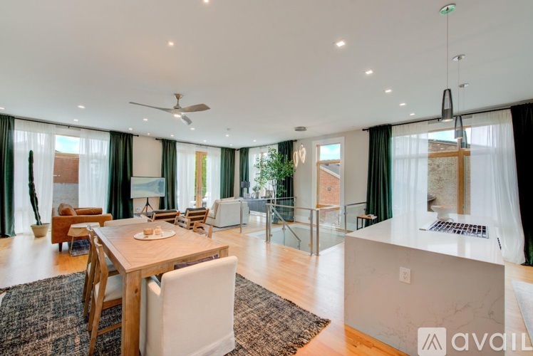 A modern dining room with a wooden table and chairs.