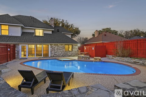 A house with a pool and two lounge chairs.