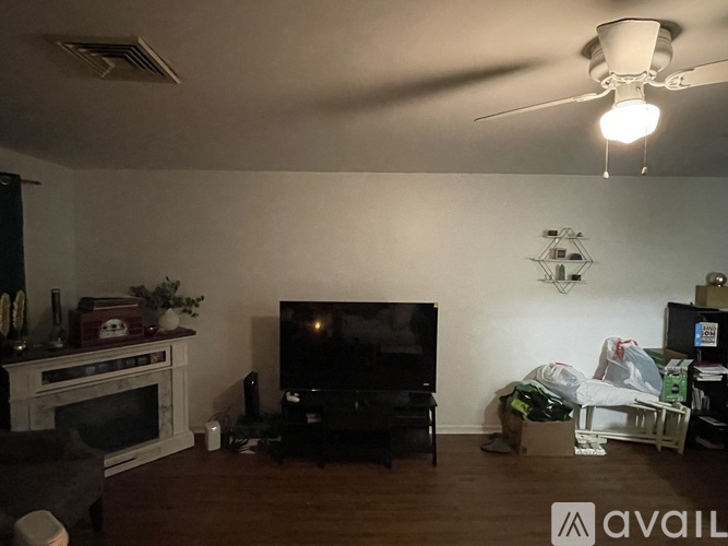 A living room with a fireplace and a television.