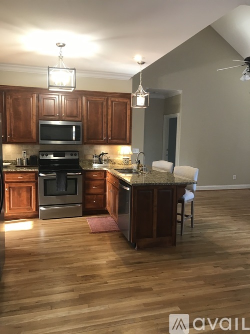 A kitchen with wooden cabinets and a granite countertop.