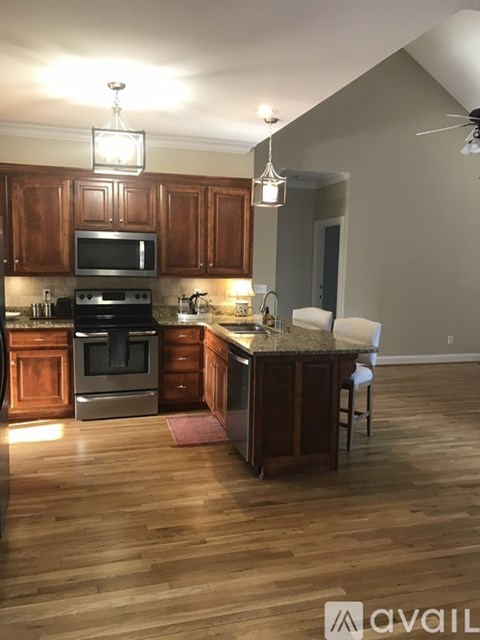 A kitchen with wooden cabinets and a granite countertop.
