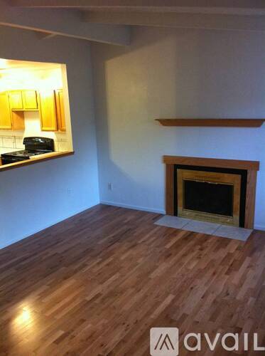 A room with a fireplace and wooden floors.