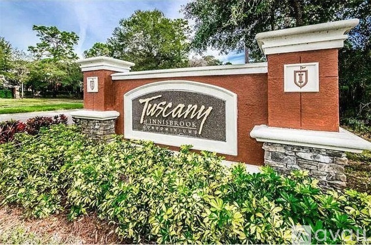 A sign that says Tuscany in front of a building.