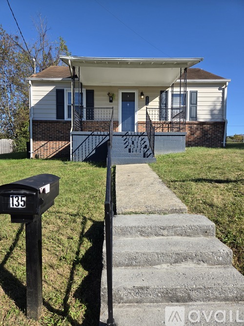 A house with a mailbox number 135 on the front porch.