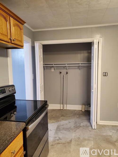 A kitchen with a black countertop and a white door.
