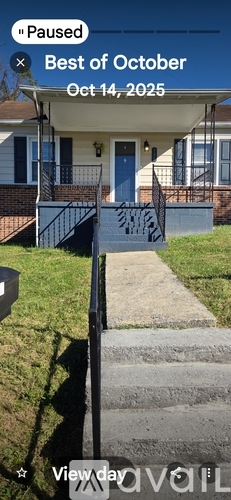 A house with a blue door and a black railing.