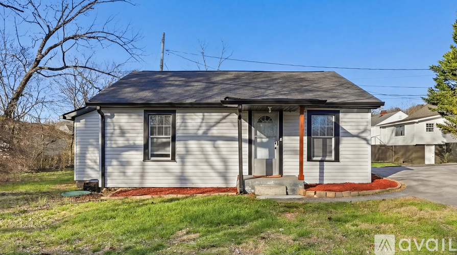 A house with a red front door and a sign that says "available".