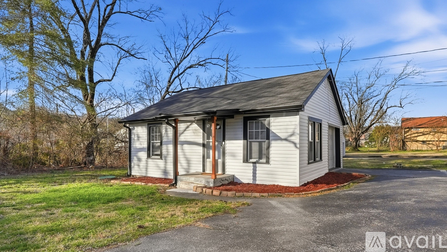 A small house with a porch is available for rent.
