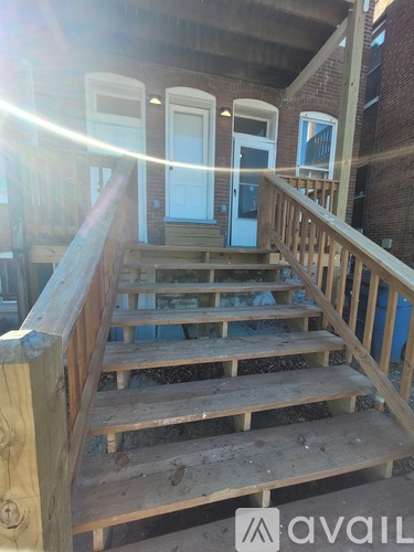 A wooden staircase leading to a door.