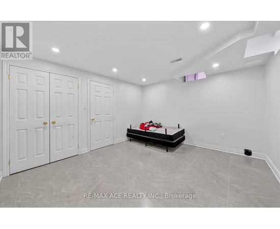 A bedroom with a bed, dresser, and wardrobe.
