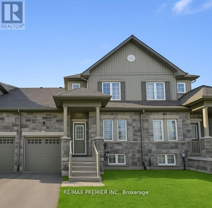 A large, two-story house with a garage is for sale.