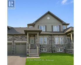 A large, two-story house with a garage is for sale.