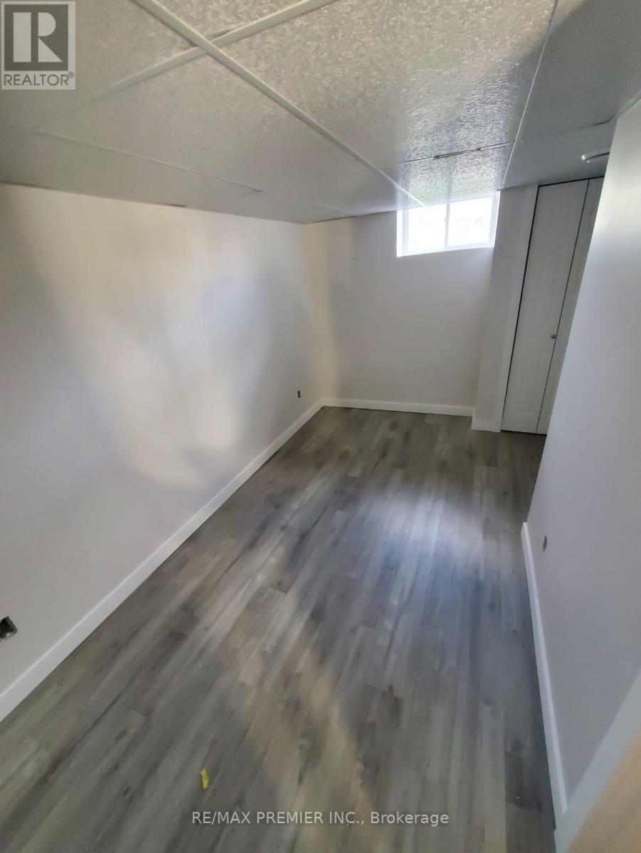 A hallway with wood flooring and white walls.