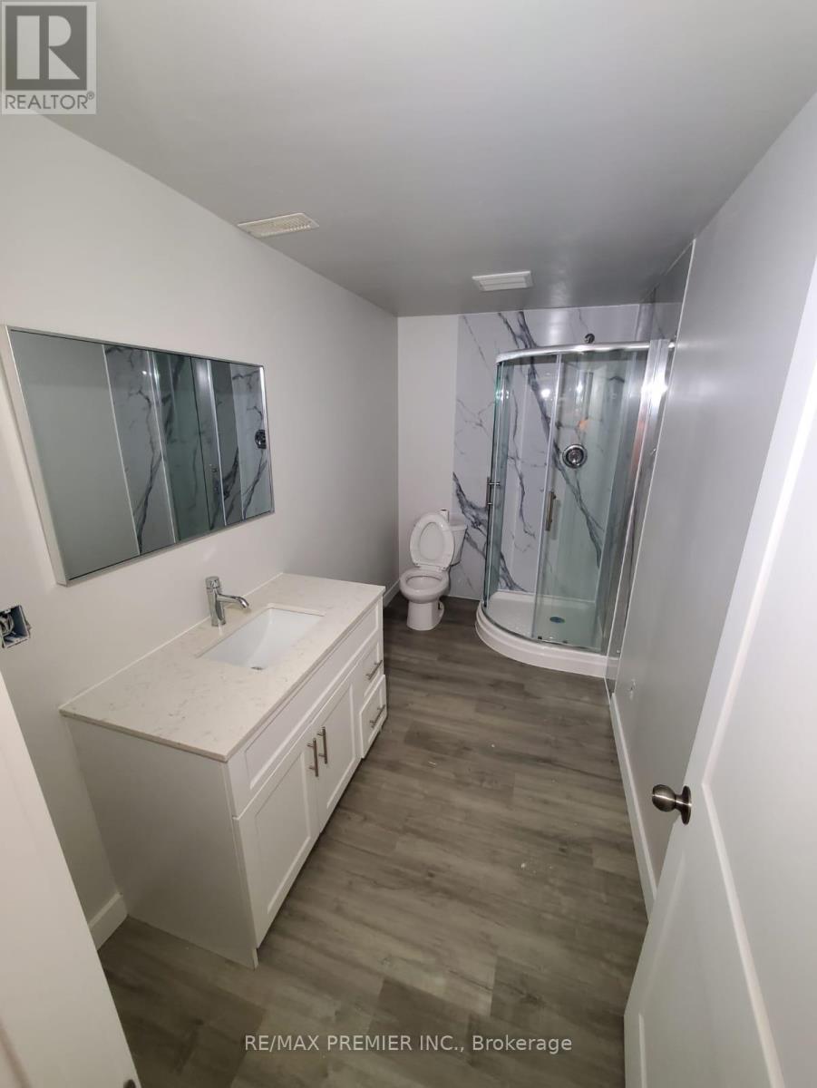 A white bathroom with a walk in shower.
