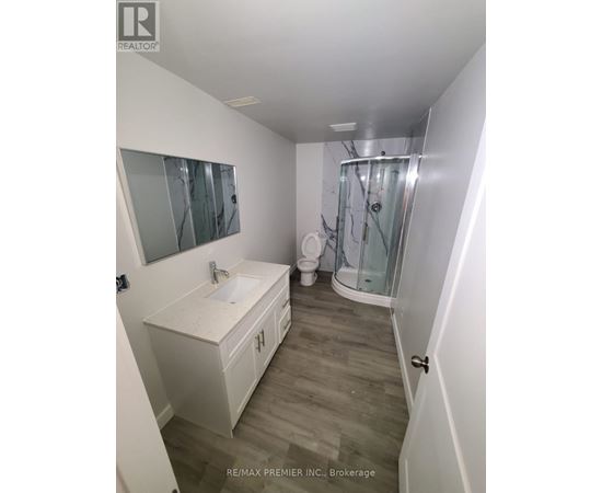A white bathroom with a walk in shower.