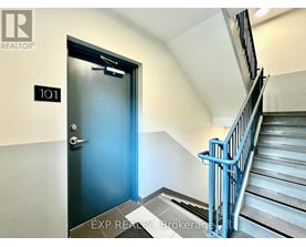 A blue door is at the end of a flight of stairs.