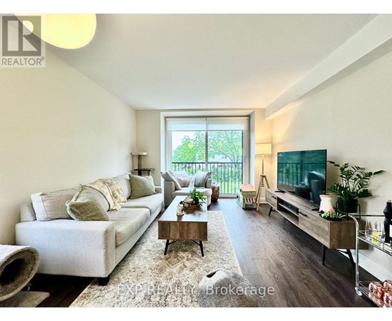 A living room with a white couch and a flat screen TV.