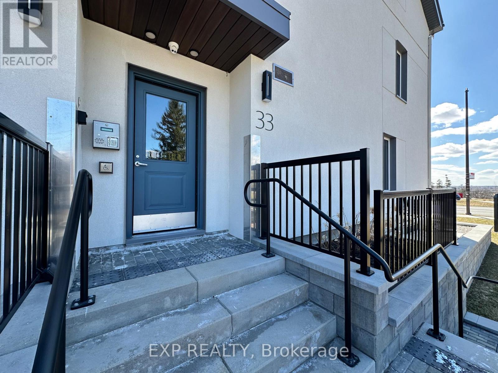 The front steps of a house with the number 33 on it.