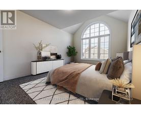 A bedroom with a large bed and a window.