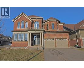 A large brick house with a garage is for sale.