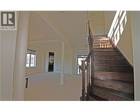 A wooden staircase leads up to a second floor.
