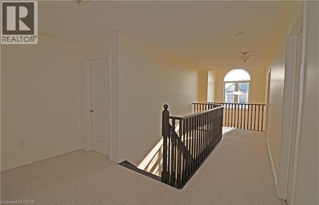 A spacious room with a balcony and a door.