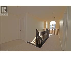 A spacious room with a balcony and a door.