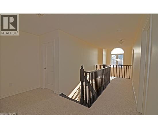 A spacious room with a balcony and a door.
