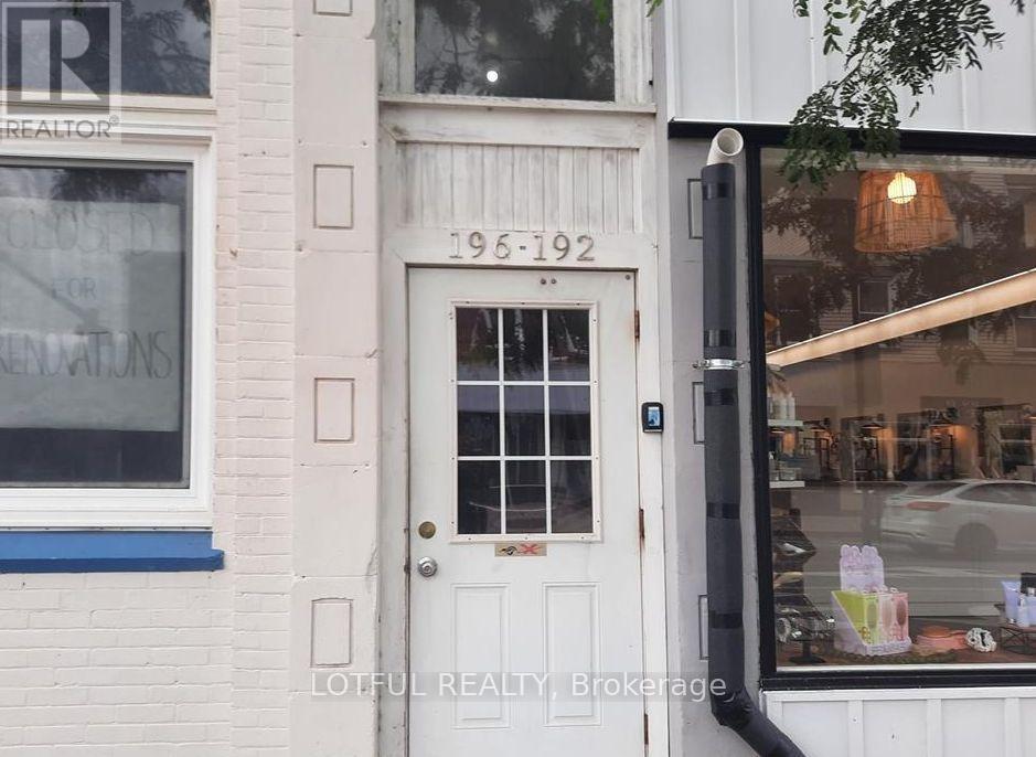 A white door with a glass window and a sign that says 1951-1992 on it.