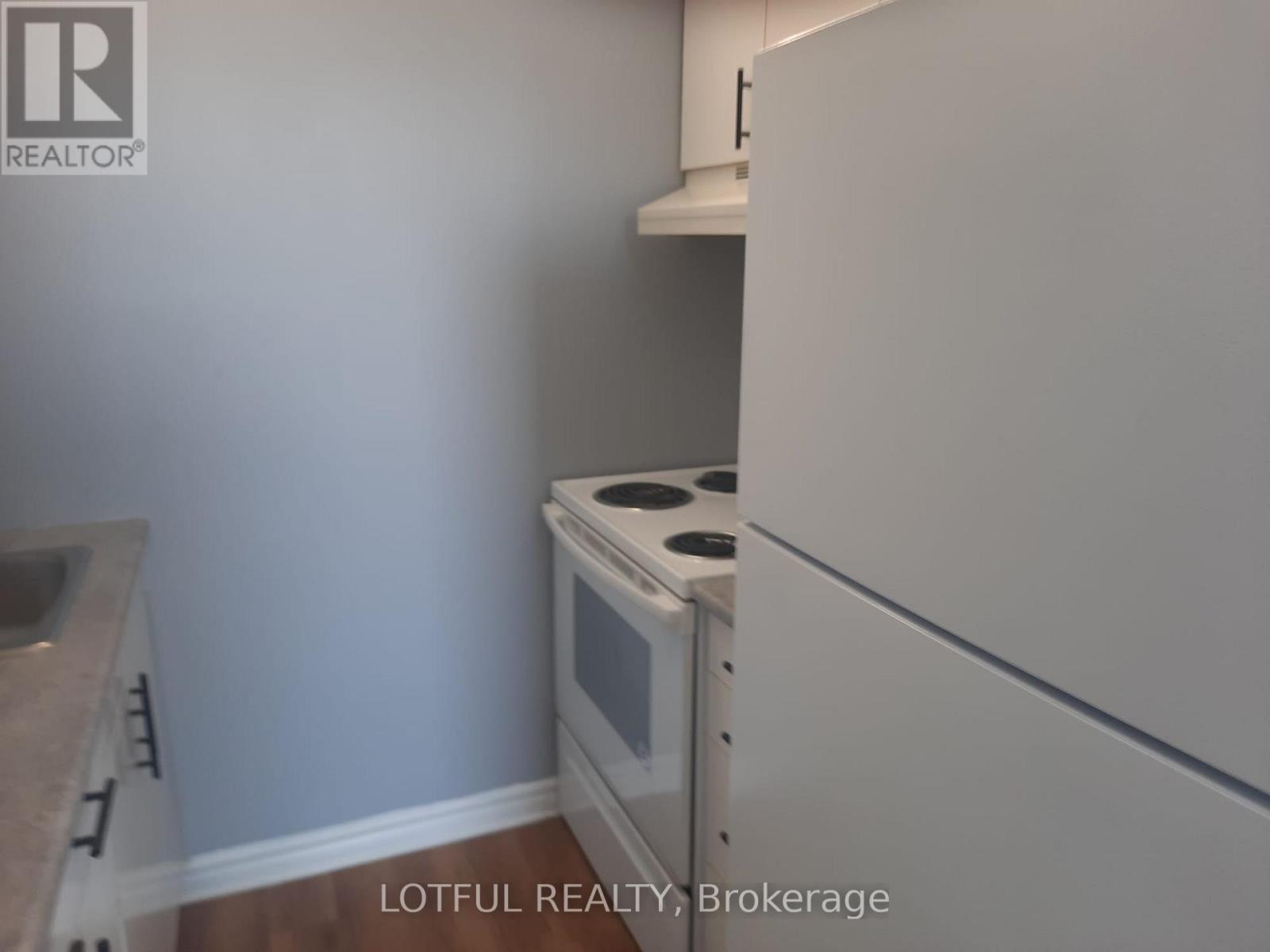 A kitchen with a stove and a sink.