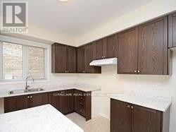 A kitchen with wooden cabinets and a white countertop.