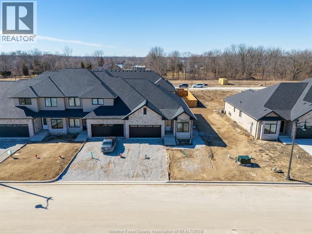 A real estate photo of a house with a car parked in front.