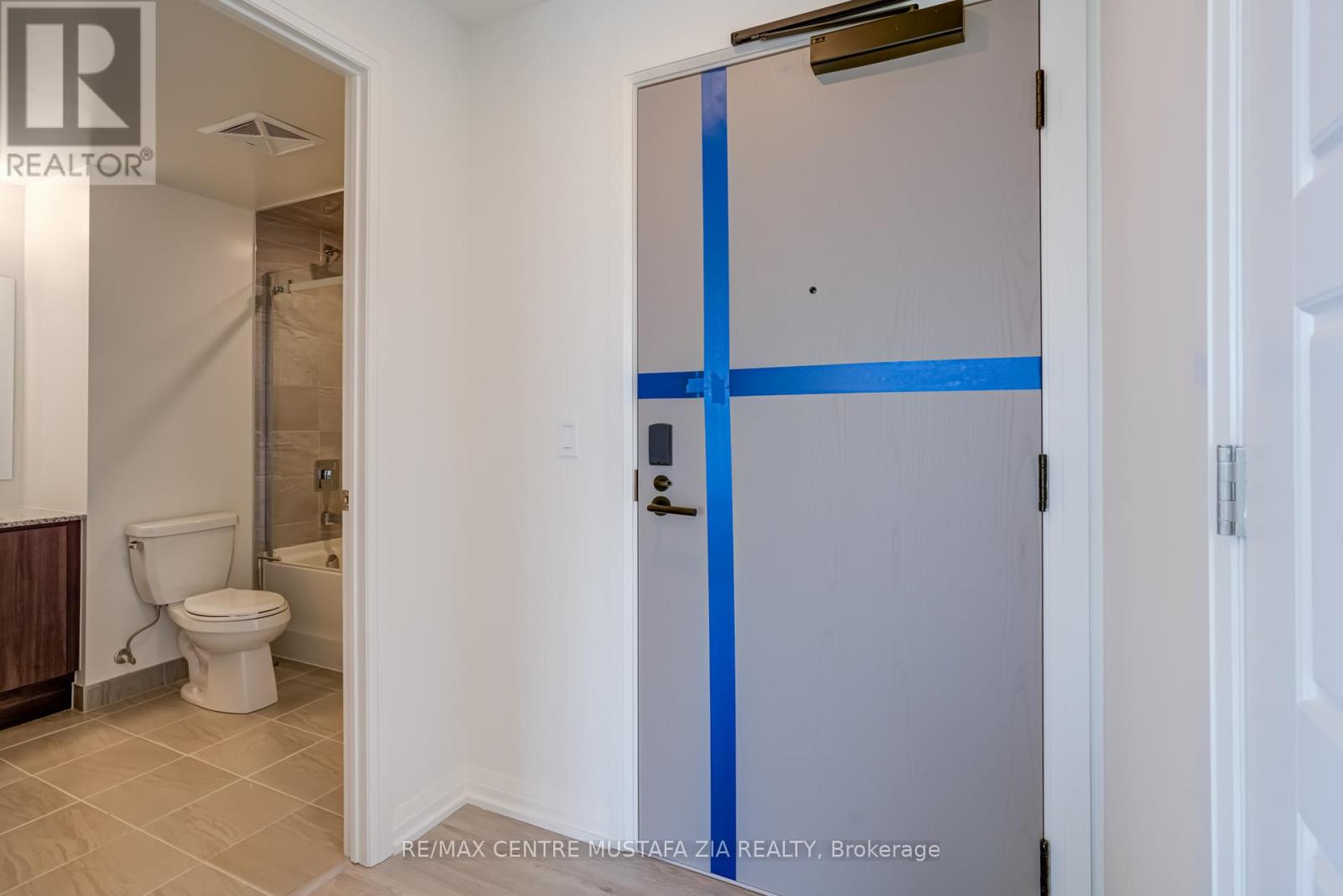 A bathroom with a toilet and a shower stall.