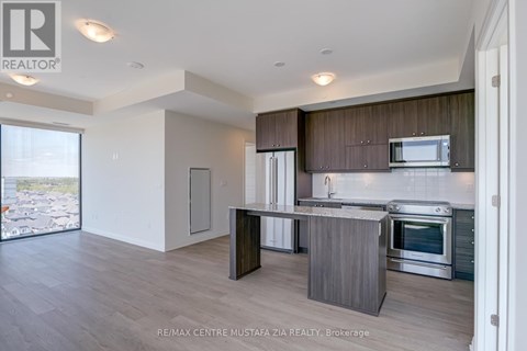 A modern kitchen with wooden cabinets and stainless steel appliances.