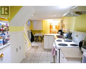 A kitchen with yellow walls and white appliances.