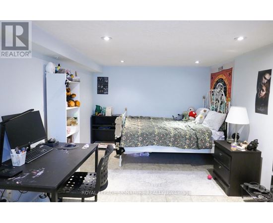 A bedroom with a bed, desk, and chair.