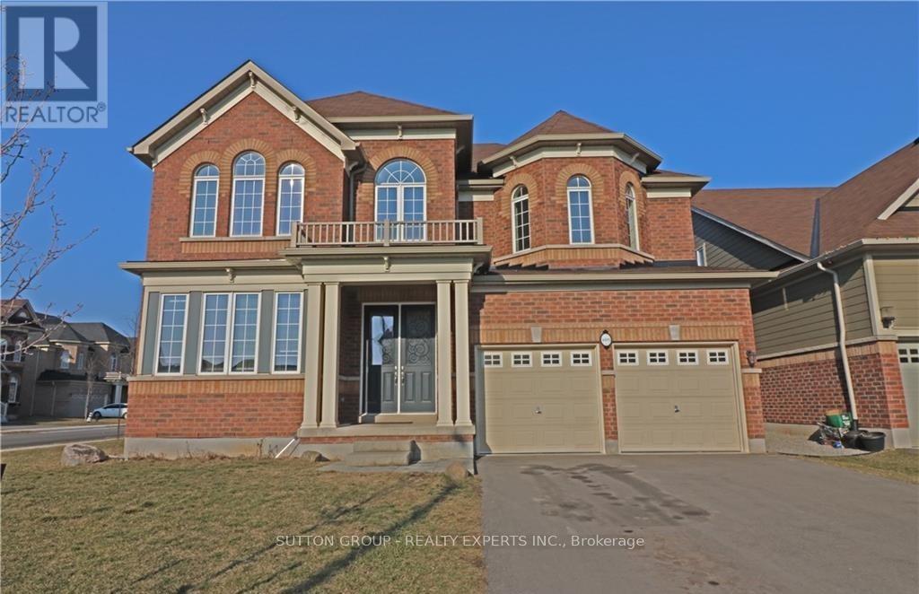 A large brick house with a garage is for sale.