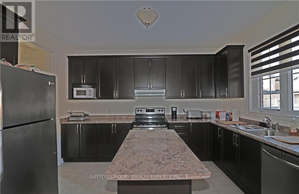 A kitchen with granite countertops and stainless steel appliances.