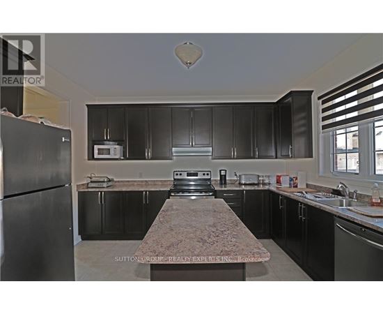 A kitchen with granite countertops and stainless steel appliances.