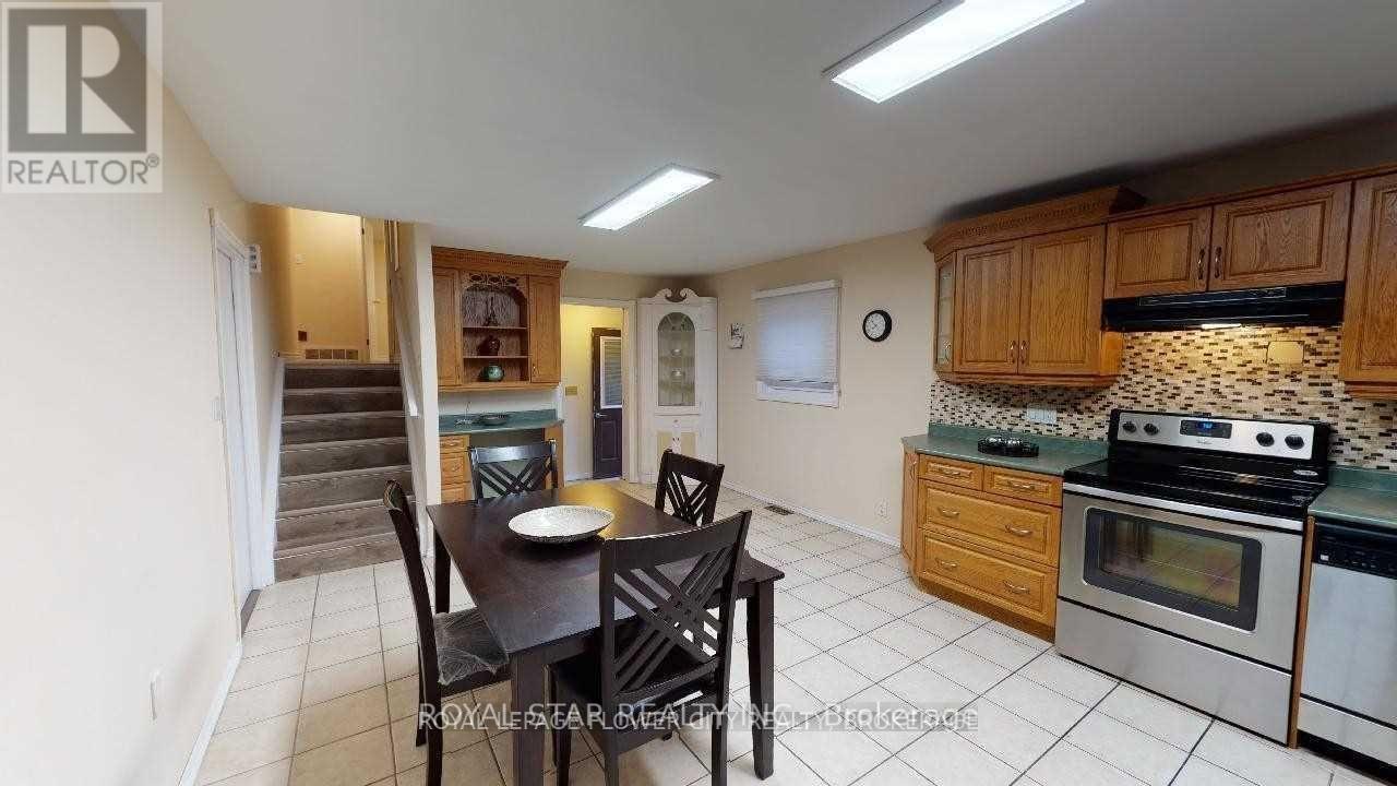 A kitchen with a table and chairs in the middle of the room.