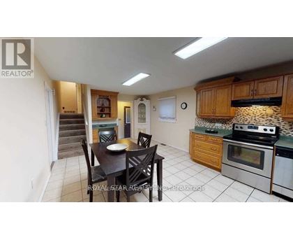 A kitchen with a table and chairs in the middle of the room.